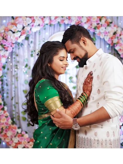 An intimate and romantic portrait of the newly engaged couple, surrounded by beautiful floral decor.