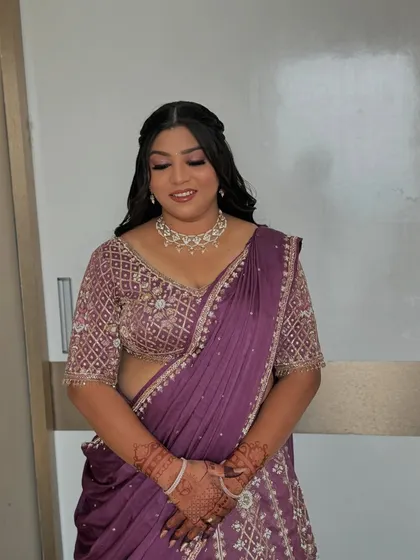 The sister of the bride, looking regal in a purple lehenga for the wedding day.