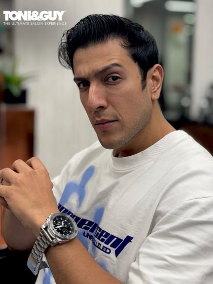 A classic, suave hairstyle with a clean side part. This timeless look is perfect for any occasion and showcases our ability to deliver polished and sophisticated men's grooming.