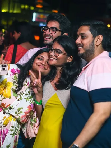 A group of friends taking a selfie to remember the night.
