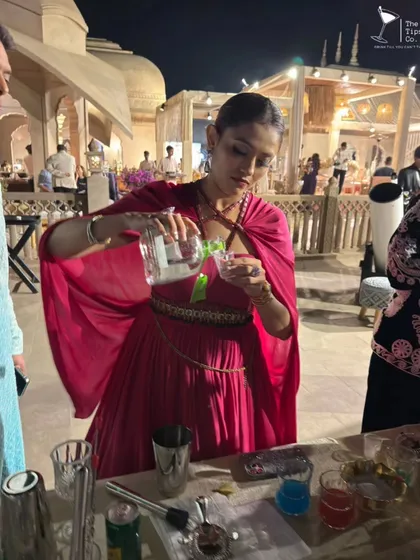 A guest at a wedding takes her turn behind the bar during our interactive cocktail workshop. We love creating opportunities for guests to get involved and make their own drinks.