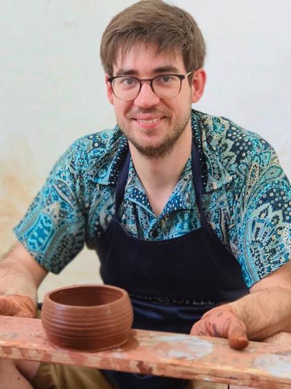 A happy international student shows off the textured bowl he created. Pottery is a universal language, and we love sharing it with people from all walks of life.