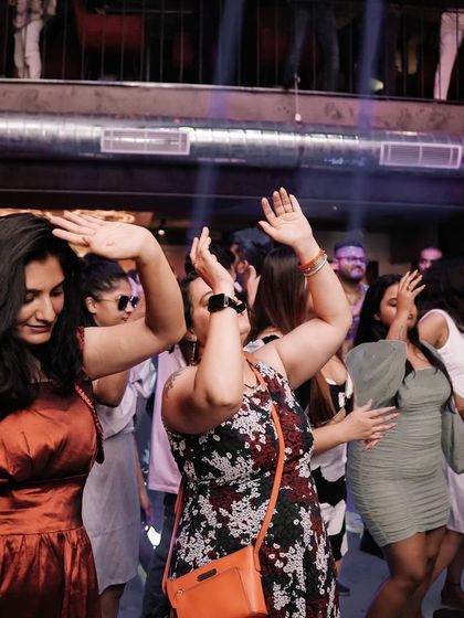 The crowd dancing under the club lights at Flo, a perfect symphony of movement and music.