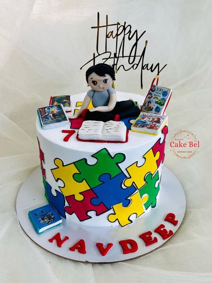 Another angle of the puzzle and mythological books cake.