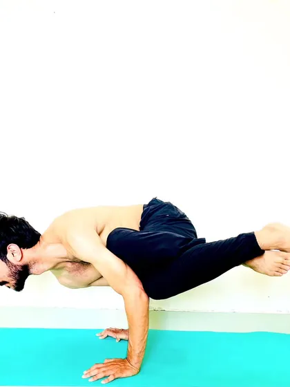 Parsva Bakasana (Side Crane Pose), an arm balance that adds a deep twist to challenge the core and obliques.