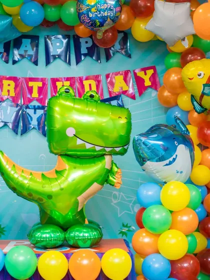 A roaring dinosaur and shark theme. We use large, colorful foil balloons and coordinated balloon arrangements to bring the underwater and prehistoric worlds to life.
