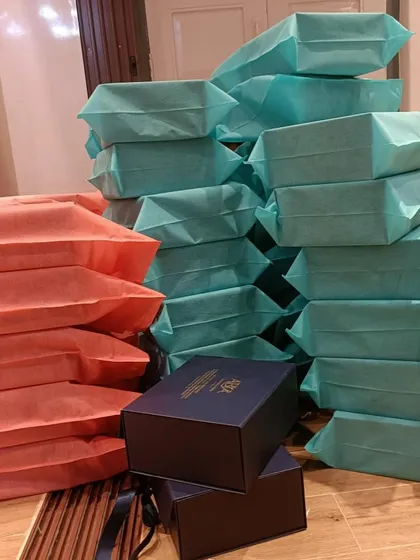 Stacks of my products being prepared for corporate gifting, beautifully wrapped and ready to share the gift of wellness.