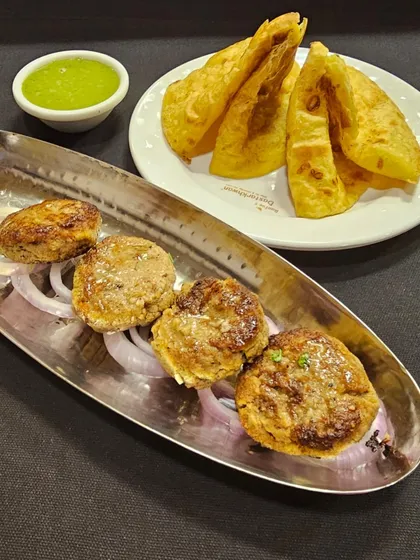 My Nawabi-style Galouti Kebabs served with flaky parathas. These kebabs are incredibly soft and melt in your mouth, offering an authentic taste of Lucknowi cuisine.