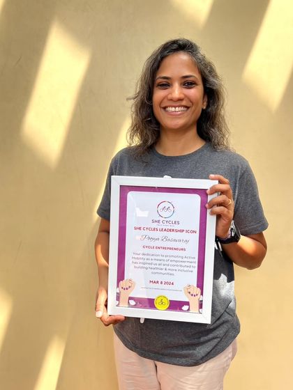 My co-founder Poojya, a passionate cyclist and instructor, holding her She Cycles Leadership Icon award. Her expertise and dedication are at the heart of our Cycle School's success.