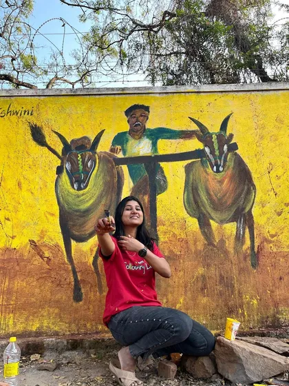 Here I am with a finished mural in Dharwad celebrating local culture. This piece depicts a traditional bull race, painted with bold, energetic colours to capture the excitement of the event. It was a joy to bring this piece of Namma Hubballi-Dharwad to life.