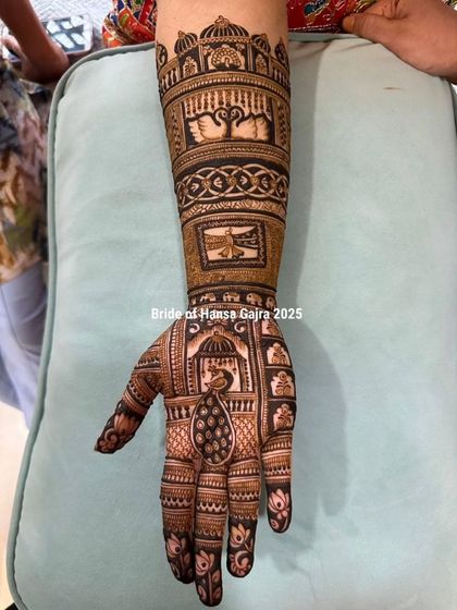 The front of a traditional bridal hand, featuring a graceful peacock in a jharokha (window), swan motifs, and other story elements, all crafted with precision and love.
