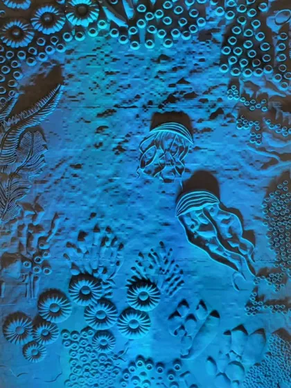 Another view of the coral wall illuminated in blue. The lighting design was critical to the story, representing the cool, vibrant life of a healthy reef that is now under threat.
