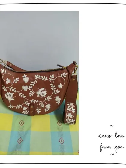 A closer look at a custom Caro bag for our patron Pranali. This piece features our white Lace embroidery with bird motifs on a classic tan leather, paired with a matching embroidered mini charm.