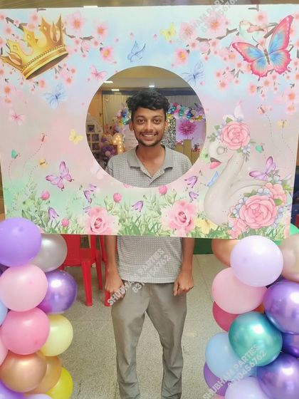 A fun photo booth frame with a butterfly and floral theme, perfect for guests to take pictures.