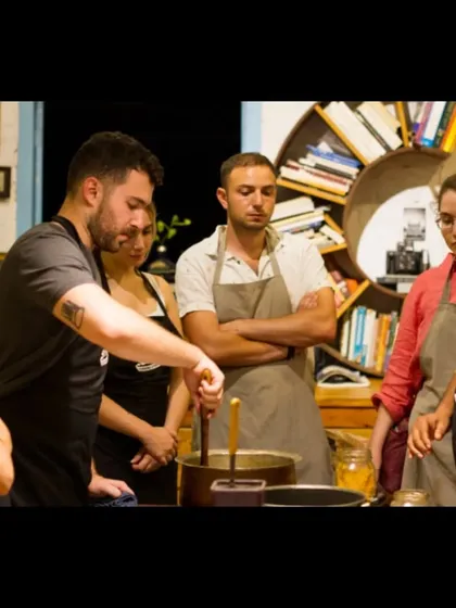 Our chef explains the importance of layering spices, a key concept in Indian cooking, to an attentive group of students.