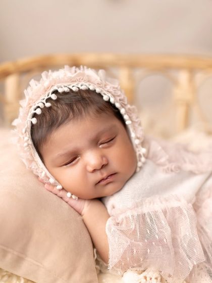 A close-up of a sleeping angel in a delicate lace bonnet. These tiny details are what make newborn portraits so special.