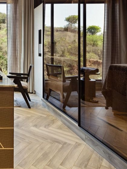 The timeless elegance of wooden flooring is a key feature in Terra. Here, the herringbone pattern in the walk-in closet adds warmth and richness, complementing the natural materials used throughout the home.