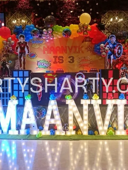 We bring superhero fantasies to life with action-packed stage designs. This Avengers-themed birthday setup features dynamic character cutouts, vibrant balloon arrangements, and large marquee letters spelling out the birthday boy's name, creating an epic backdrop for the celebration.