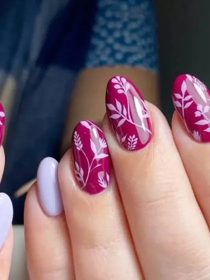 A beautiful botanical design with delicate white leaf patterns painted over a rich magenta base.