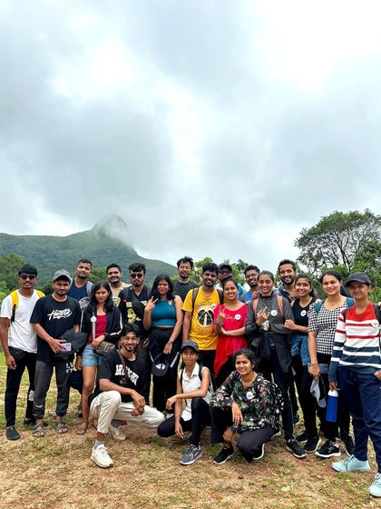 The group on the trail with a misty peak in the background.