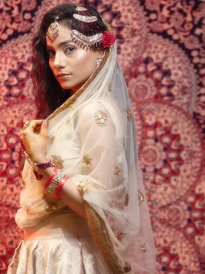A beautiful portrait capturing the elegance of a traditional veil, or dupatta, and how it frames the face and makeup.