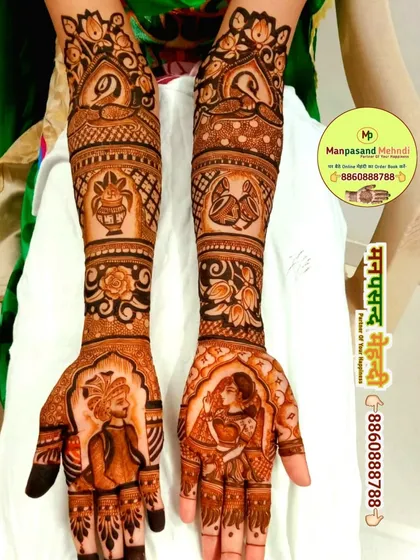 A classic bride and groom portrait design, with intricate details on their attire. The arms are adorned with peacocks, flowers, and other auspicious wedding symbols.
