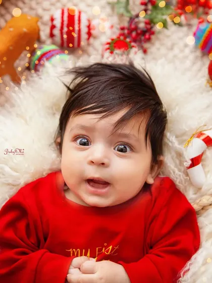 A look of pure wonder. This close-up from a 'My First Christmas' session captures the magic of the holidays through a baby's eyes.