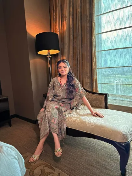 The bride relaxing before her Mehendi event. The soft glam makeup looks effortless and chic, perfect for the intimate celebration.