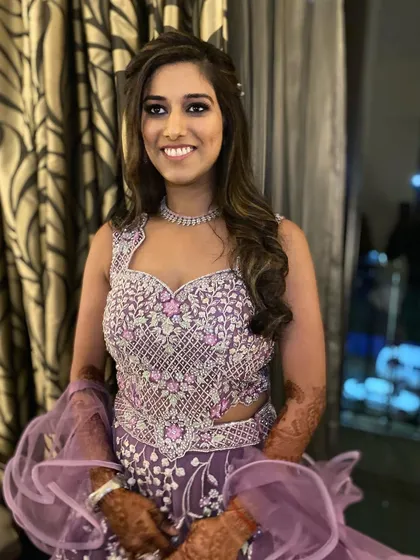 A happy Sangeet bride ready for her party. The combination of glam makeup and soft, wavy hair created a balanced and beautiful look.