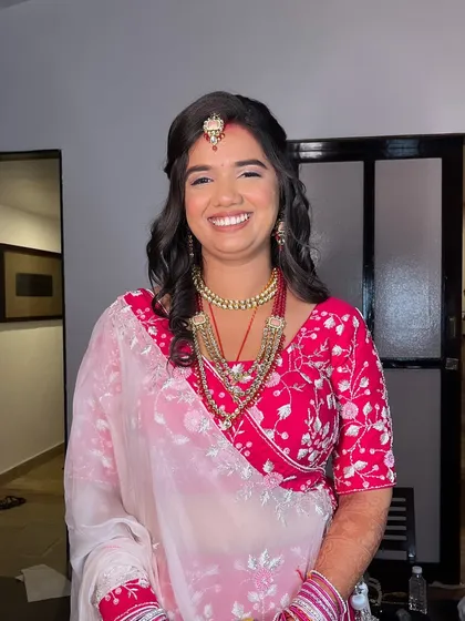 The complete reception look for Ayushi. Her traditional jewelry and modern hairstyle are perfectly balanced by the soft glam makeup.