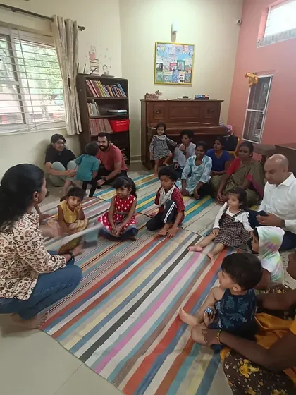 A candid moment of interaction between the storyteller and the children before the main story begins.