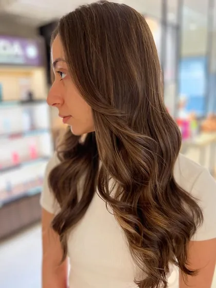 A lovely two-tone caramel highlight blend created without bleach. This technique keeps the hair healthy while adding beautiful, warm dimension.