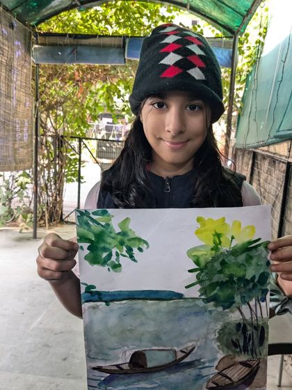 A peaceful scene of a boat on the water, painted with watercolors. This student has beautifully captured the reflections and the lush greenery.