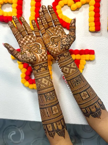 An angled view of the bridesmaid's henna against a festive background.