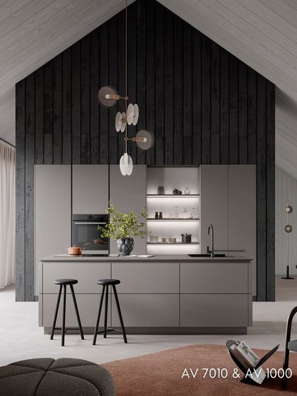 Another view of the AV 7010 & AV 1000 kitchen, showcasing the play of textures between the concrete-finish cabinets and the smooth, matte surfaces.