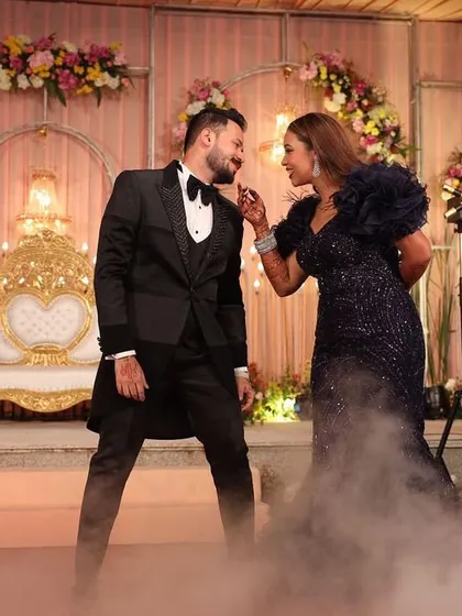 A moment of pure connection during a sangeet performance. We use elements like dry ice to create a dreamy, dancing-on-clouds effect for our couples.