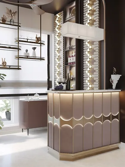 The warm, ambient lighting highlights the textures and details of the bar, from the scalloped counter to the dramatic, custom light fixture on the wall.