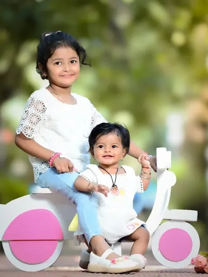 Sibling adventures are the best! Using fun props like this little scooter, I capture the playful energy and sweet friendship between sisters during a fun-filled outdoor photoshoot. These are the memories of childhood they'll look back on and smile.