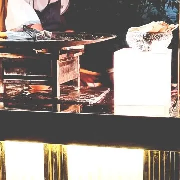 A close-up of our live tikki station at Mallu Farms. The gleaming countertop and professional setup reflect the high standards we maintain for our luxury chaat service.