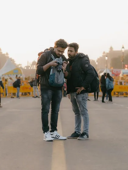 A lot of what I teach happens right on the street. Here, I'm reviewing shots on my camera with a friend at India Gate. Our sessions are collaborative, focusing on hands on learning and immediate feedback to improve your photography skills in real time.