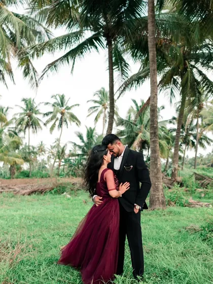 An intimate embrace amidst the serene greenery and towering palms of a destination shoot. We specialize in finding beautiful natural backdrops that complement a couple's story.