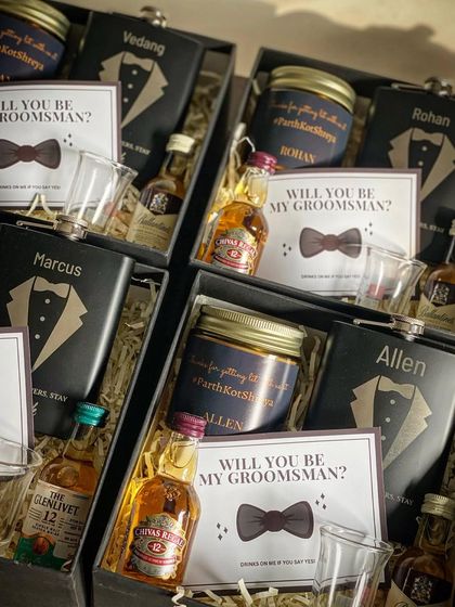 A closer look at my groomsmen proposal boxes. Each one contains a personalized hip flask, a custom scented candle, miniature whiskey bottles, and a proposal card.