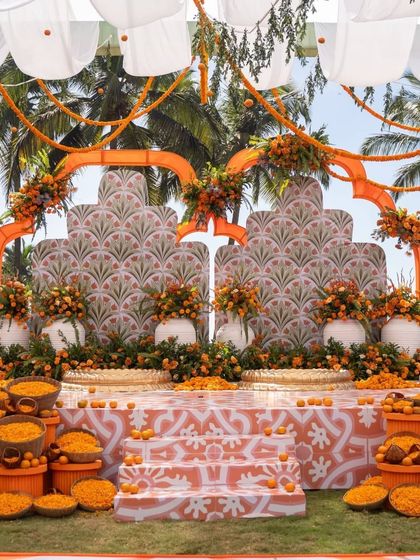 A stunning marigold-themed haldi stage with intricate patterns and a fresh, modern feel. The use of traditional flowers in a contemporary design is perfect for a destination wedding in Goa.