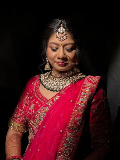 A serene portrait with dramatic, focused lighting. This shot emphasizes the flawless eye makeup and the smooth, radiant finish on the skin, showing how the look holds up under different lighting conditions.