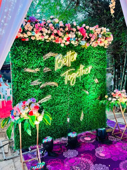 'Better Together' says it all. This photo booth features a vibrant green wall, a custom neon sign, and a colorful floral header, creating a lively and fun spot for guests.