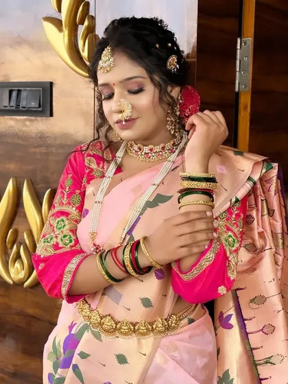 The bride adjusting her bangles, a classic pose that highlights the beautiful details of her hands, henna, and jewelry.