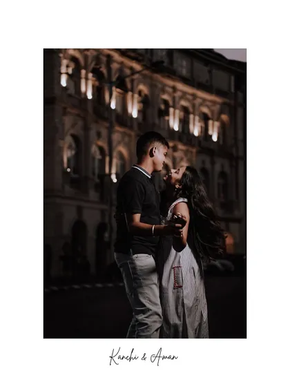 A romantic night shoot in Mumbai, with the beautifully lit heritage buildings creating a magical atmosphere. The couple is lost in their own world, a perfect example of a cinematic couple portrait.