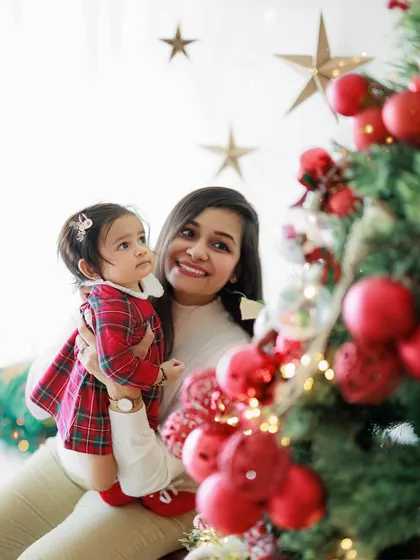 The pure sweetness and joy of a mother and daughter bond, captured during a festive Christmas mini-session. Her little girl is looking up at the tree with so much wonder.