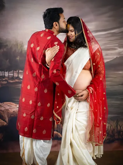 A tender kiss on the forehead. This couple's portrait in traditional Indian attire is full of warmth, love, and cultural significance.