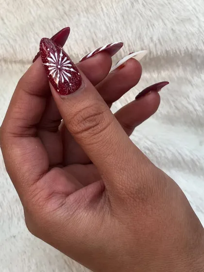 This cozy sweater nail art is perfect for Christmas. This is a press-on nail, featuring a textured design that mimics a cable-knit sweater, paired with a glittery red snowflake.